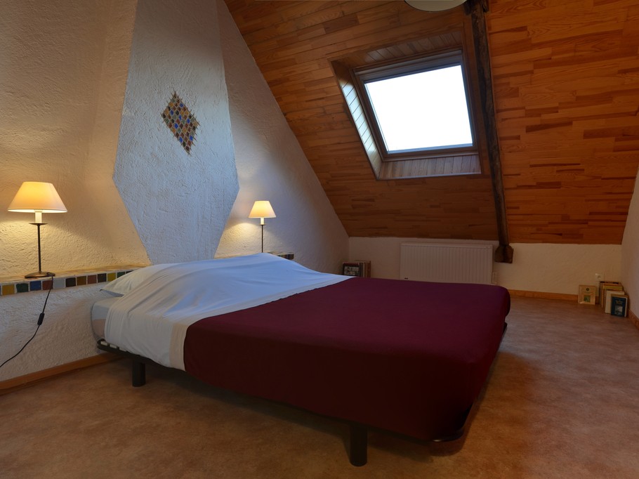 Chambre à l'étage avec un lit 160 cm cm et rangements. Belle hauteur sous plafond