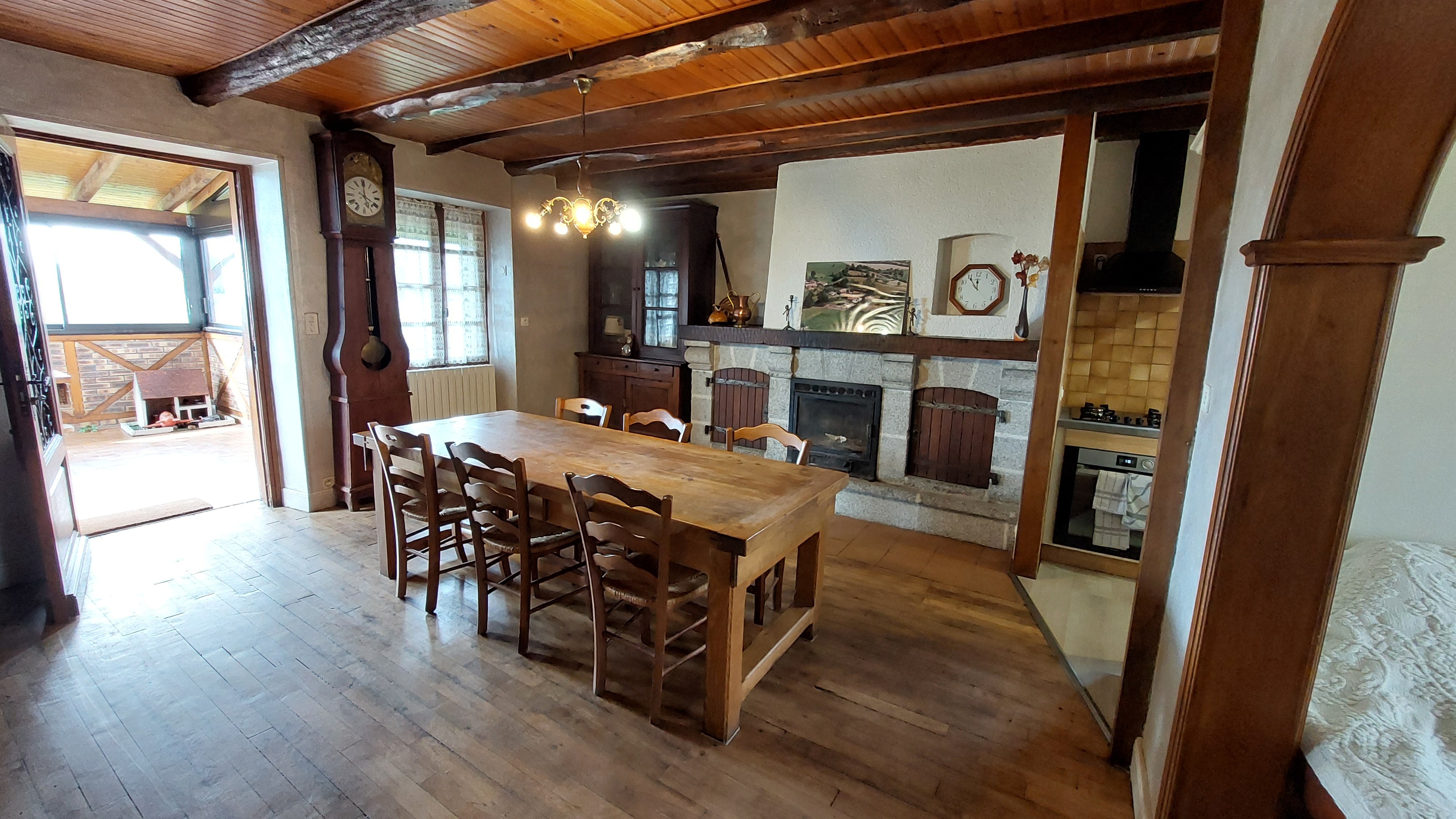 Living room with traditional fireplace and large family dining table