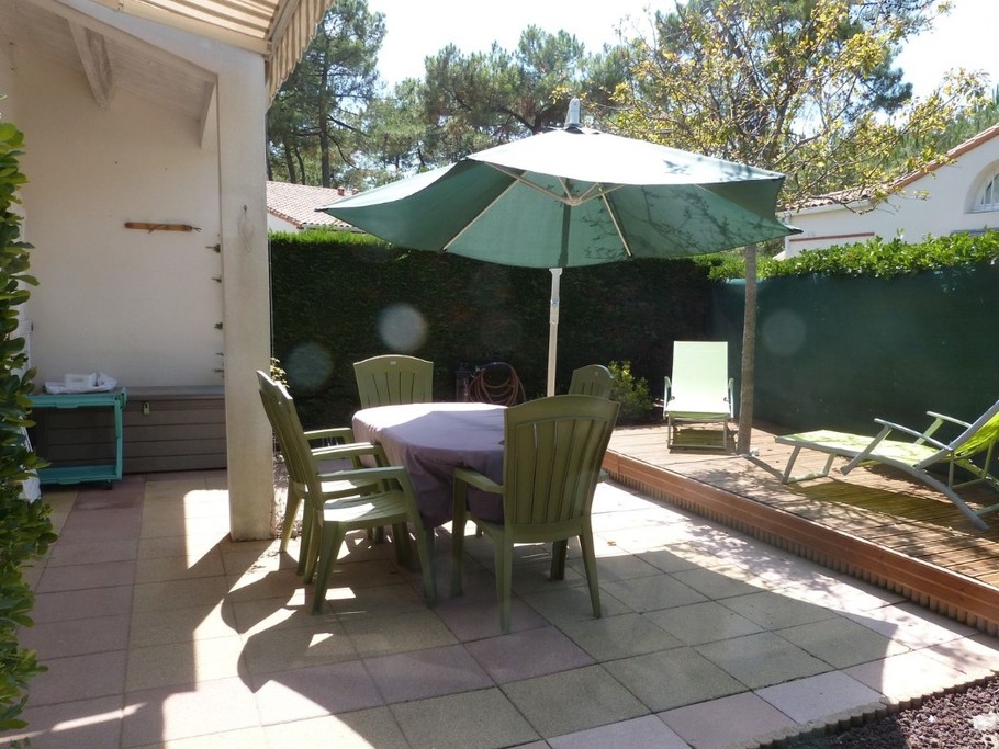 Terrasse avec salon de jardin et bains de soleil