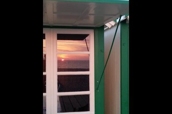 coucher de soleil vu de l'intérieur d'une cabine de plage