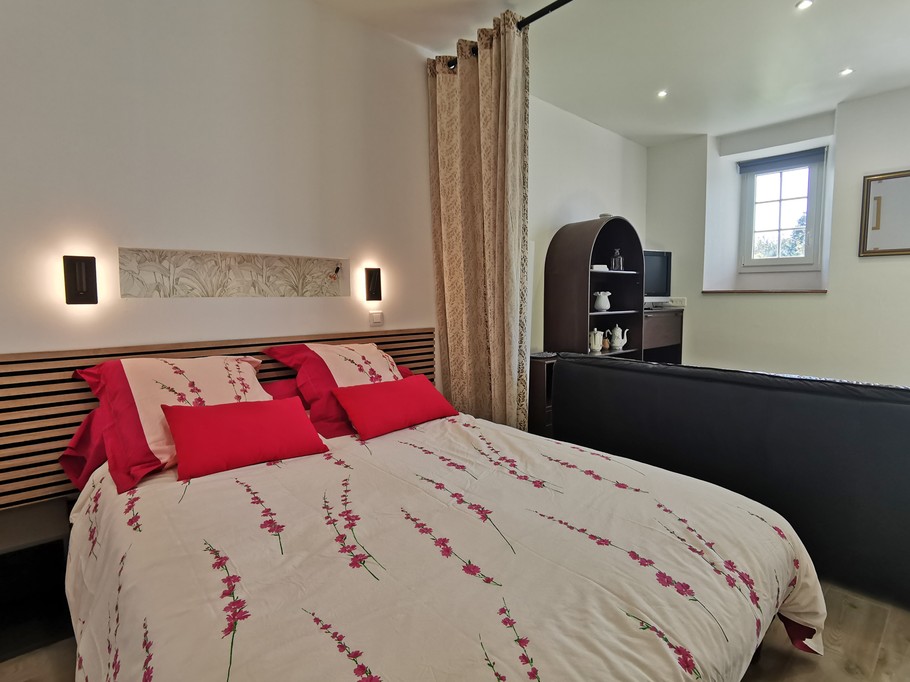 A 140 bed with a curtain separating it from the living area