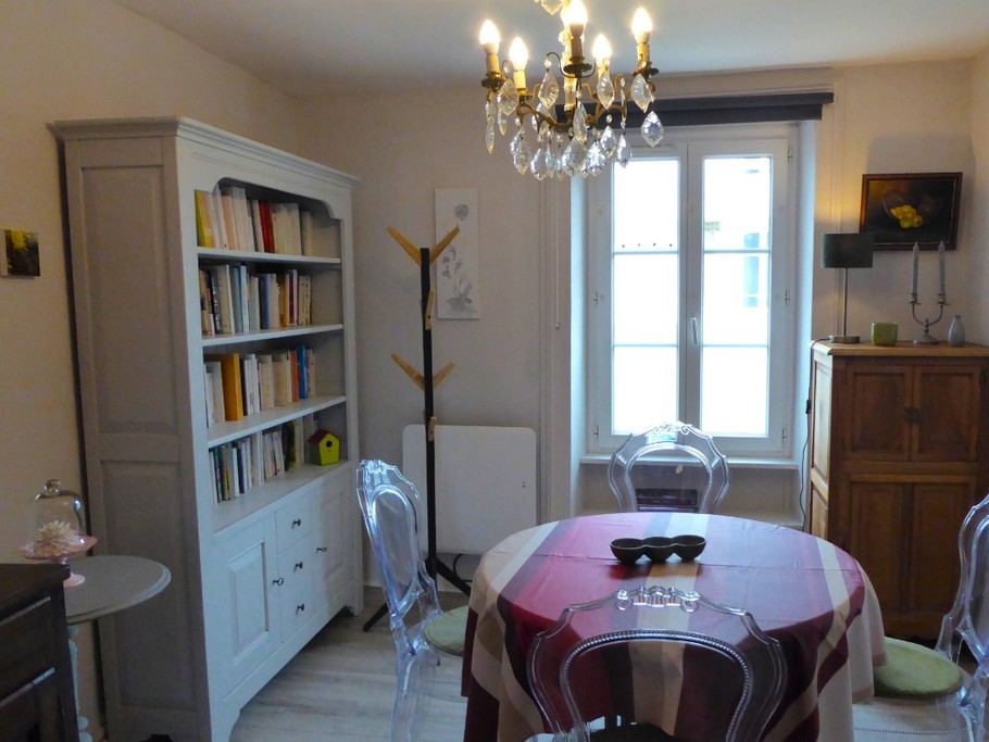 Living area with library. Separate kitchen to the left.
