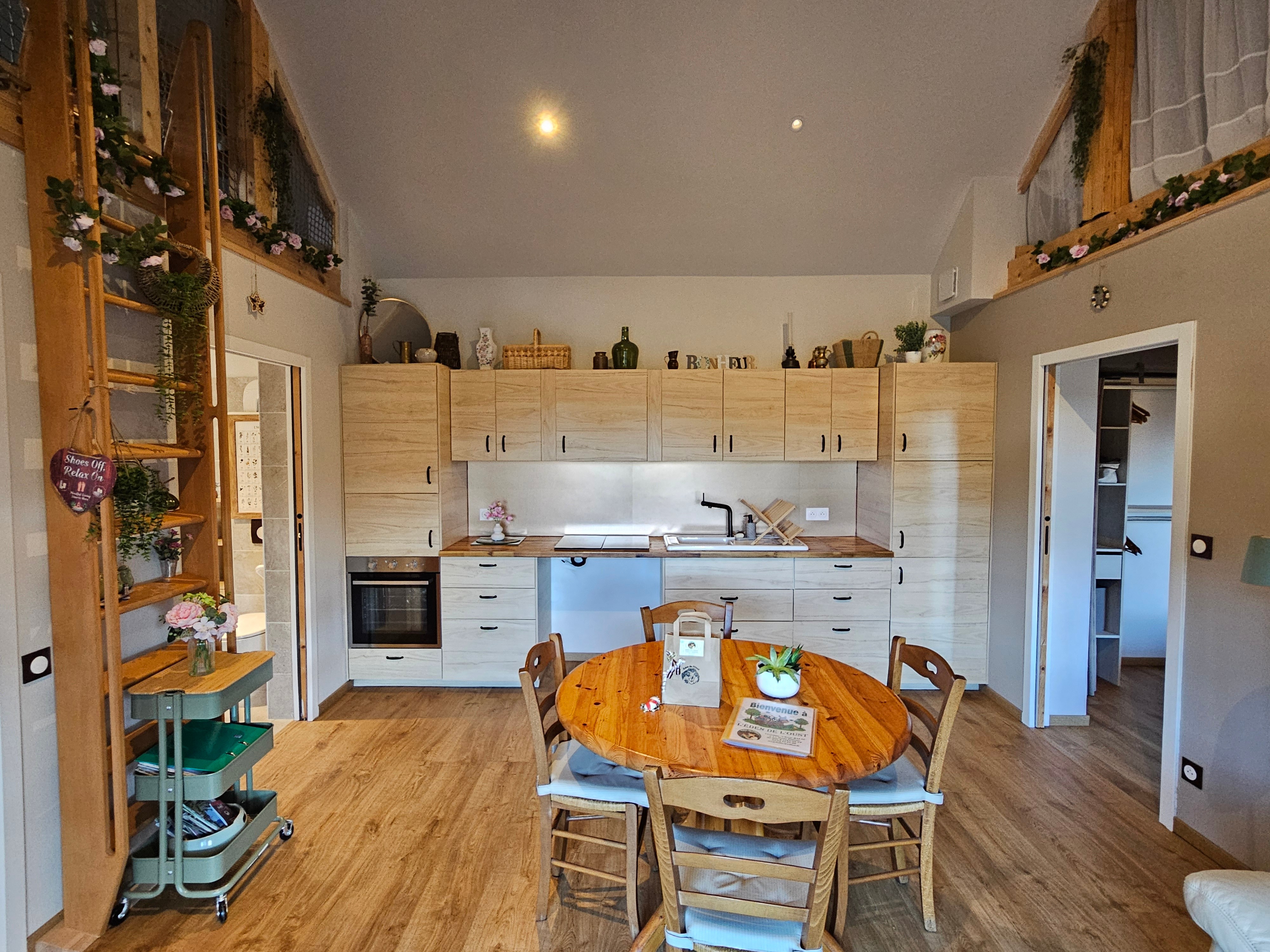 Open-plan living area with a fitted kitchen, lounge and dining table.