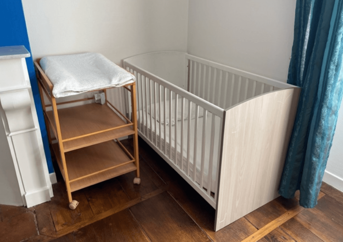 Chambre bleue avec lit bébé, table à langer et ambiance familiale près d’Aurillac