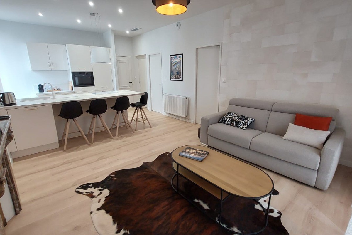 Vue d’ensemble du salon avec TV connectée et espace détente