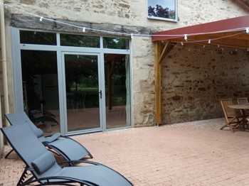 Terrasse pavée avec pergola illuminée le soir