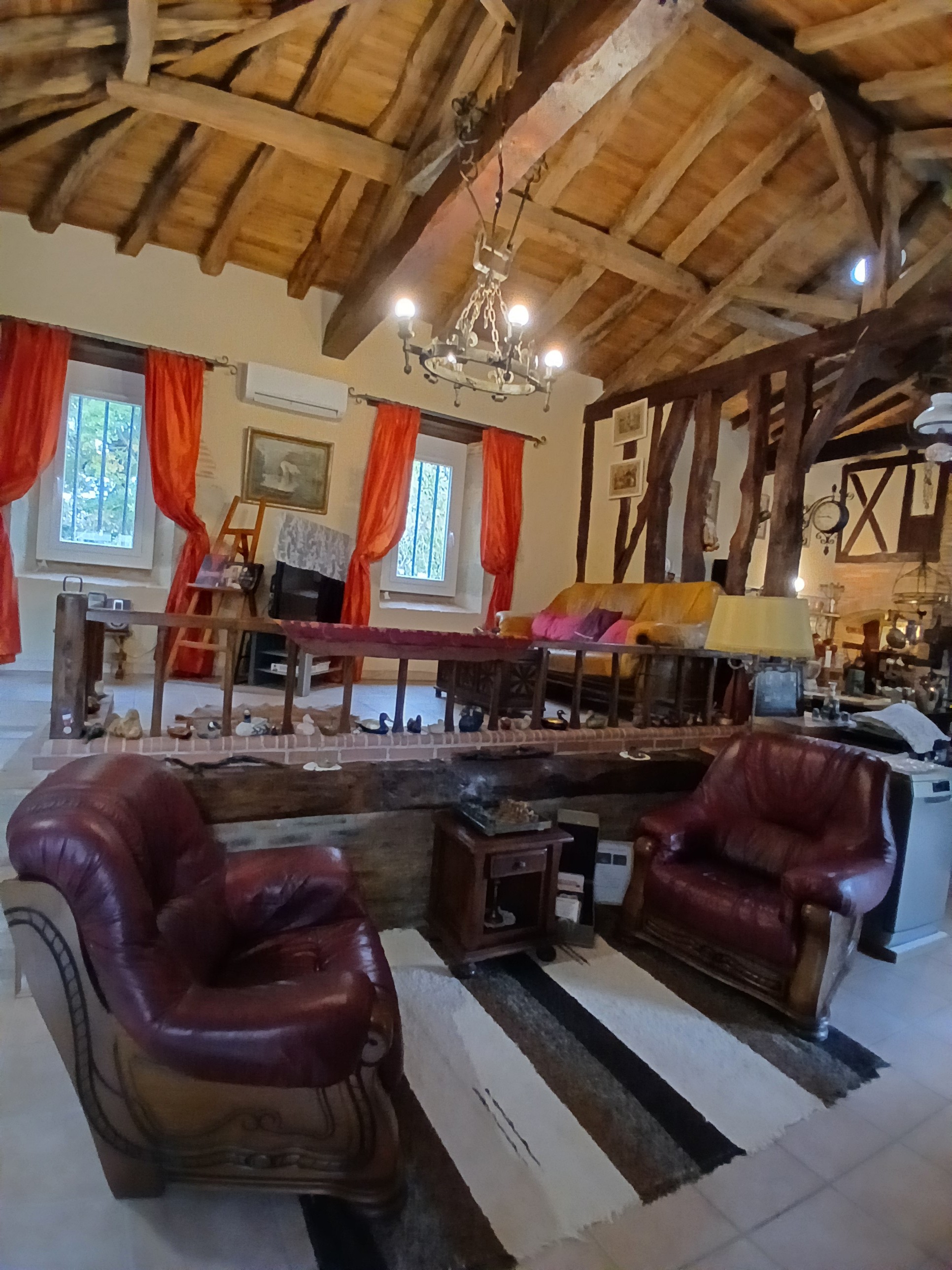 The Templar lounge with a television and hi-fi system. Collection of chess sets – Sabaillan – 4* Templar Suite – swimming pool, sauna & views of the Pyrenees, in the Gers