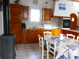 Kitchen opening onto living room and dining area