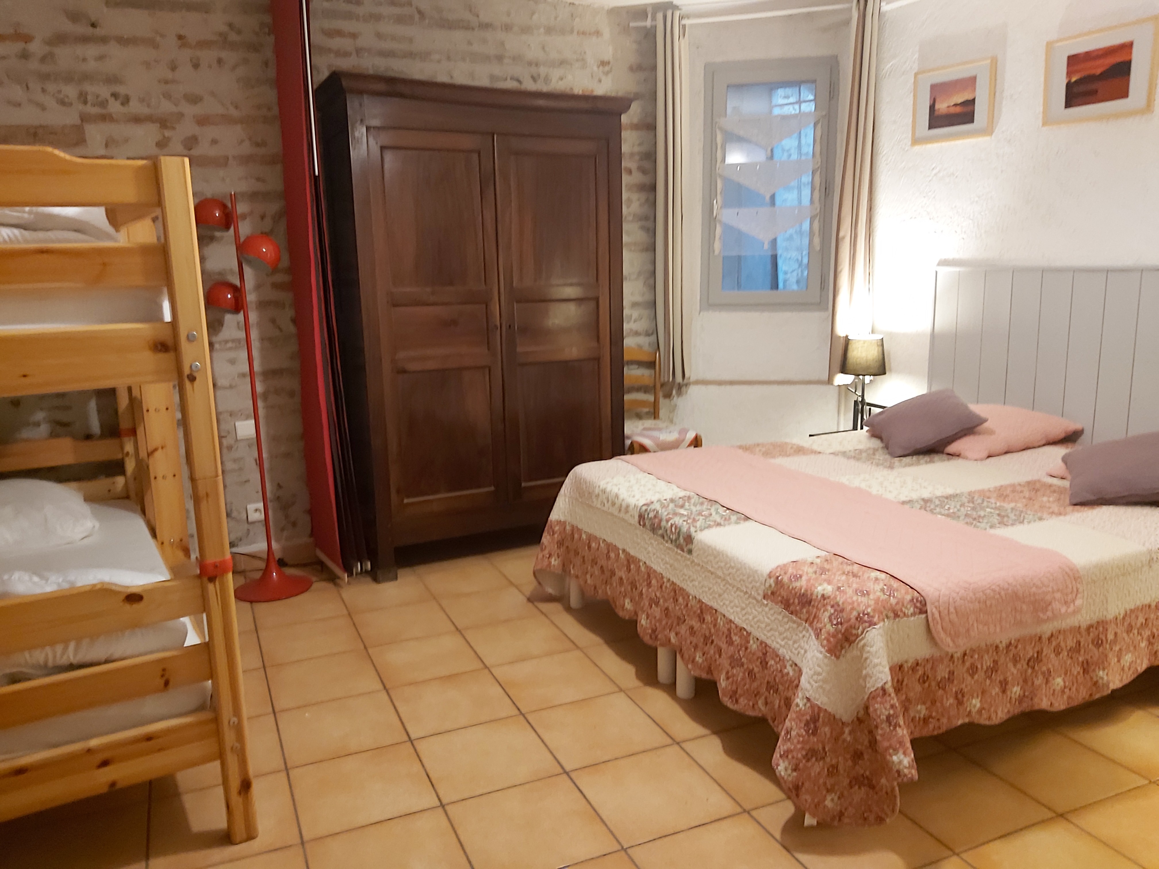 Bedroom with Japanese partition separating the double bed and bunk bed for the night