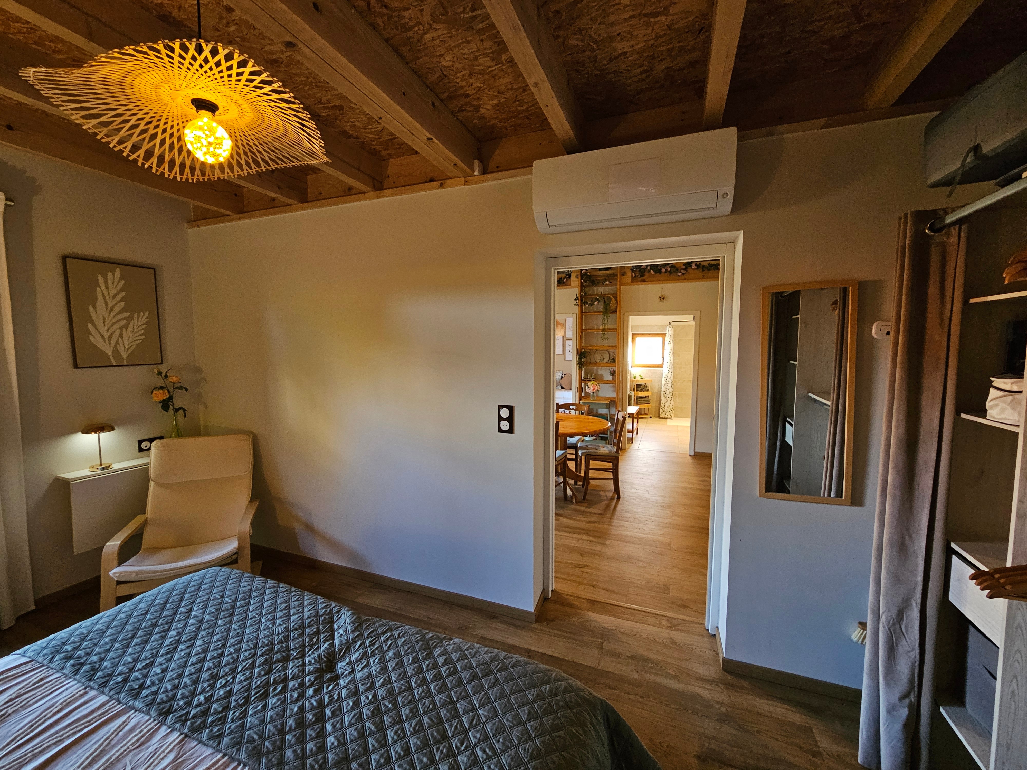 A large double bedroom with a walk-in wardrobe and a desk.