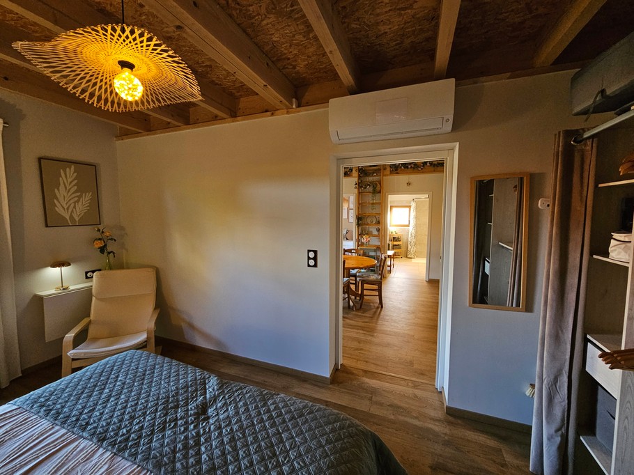 A large double bedroom with a walk-in wardrobe and a desk.