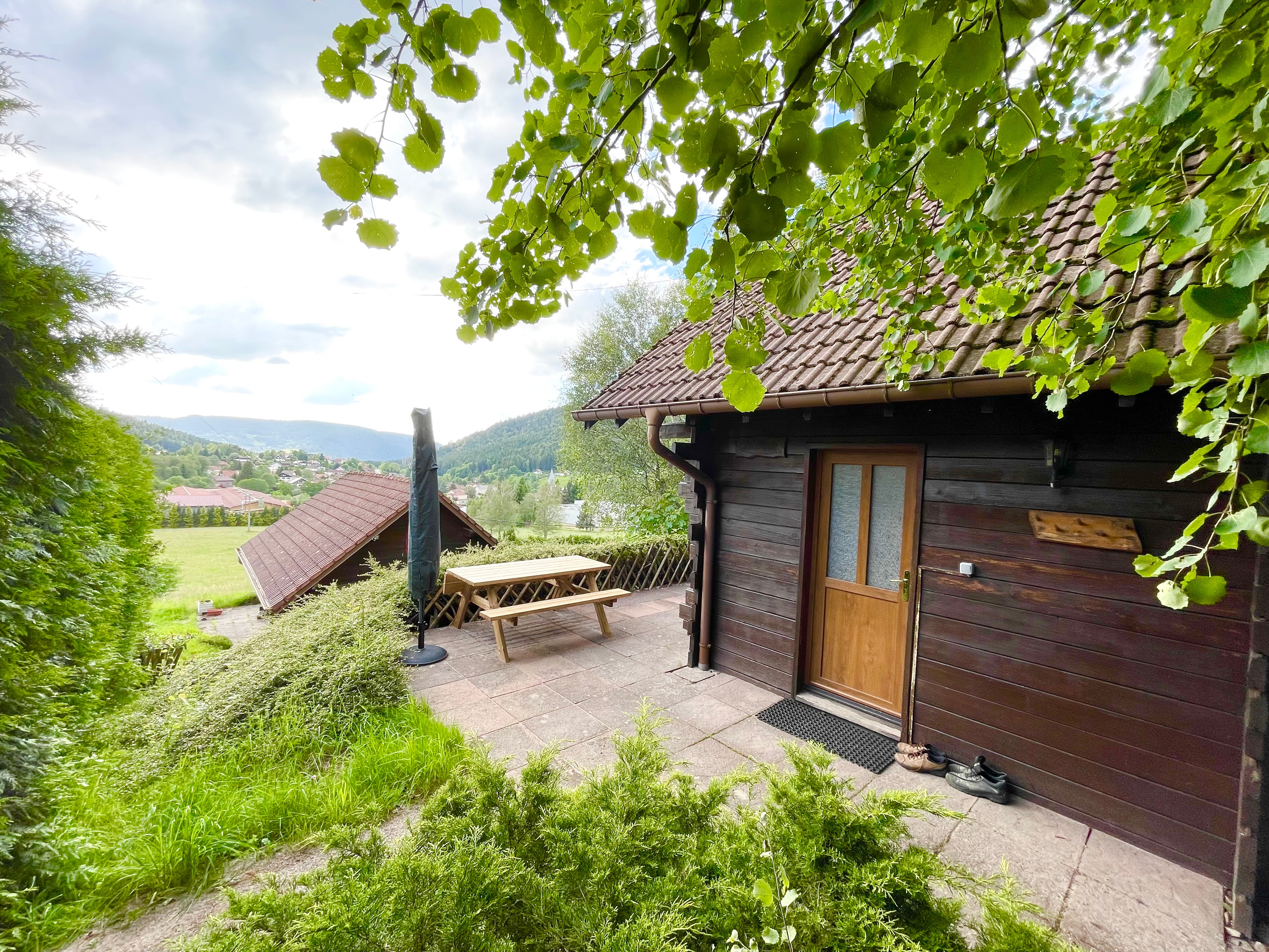The chalet set in lush greenery with panoramic views