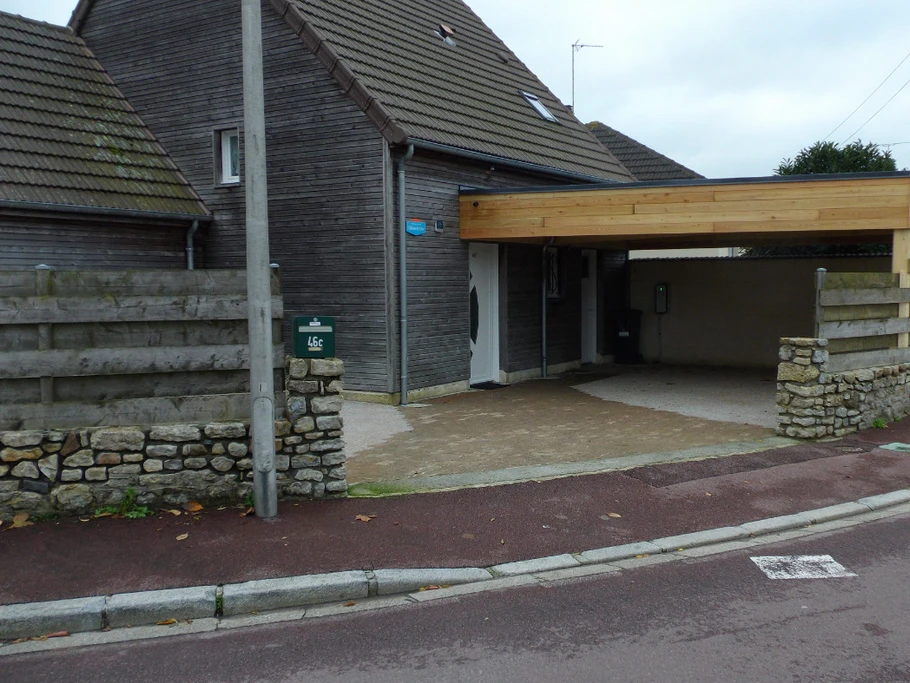 North exterior: car port and electric vehicle charging point.