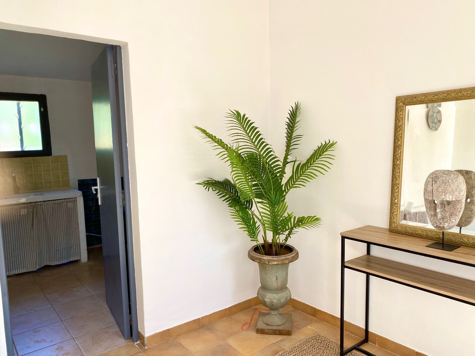 Entrance hall, leading to the utility room, and a second toilet