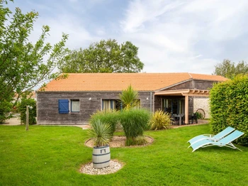 Jardin privatif avec terrasse, transats, salon de jardin, pergola, barbecue et fils à linge.