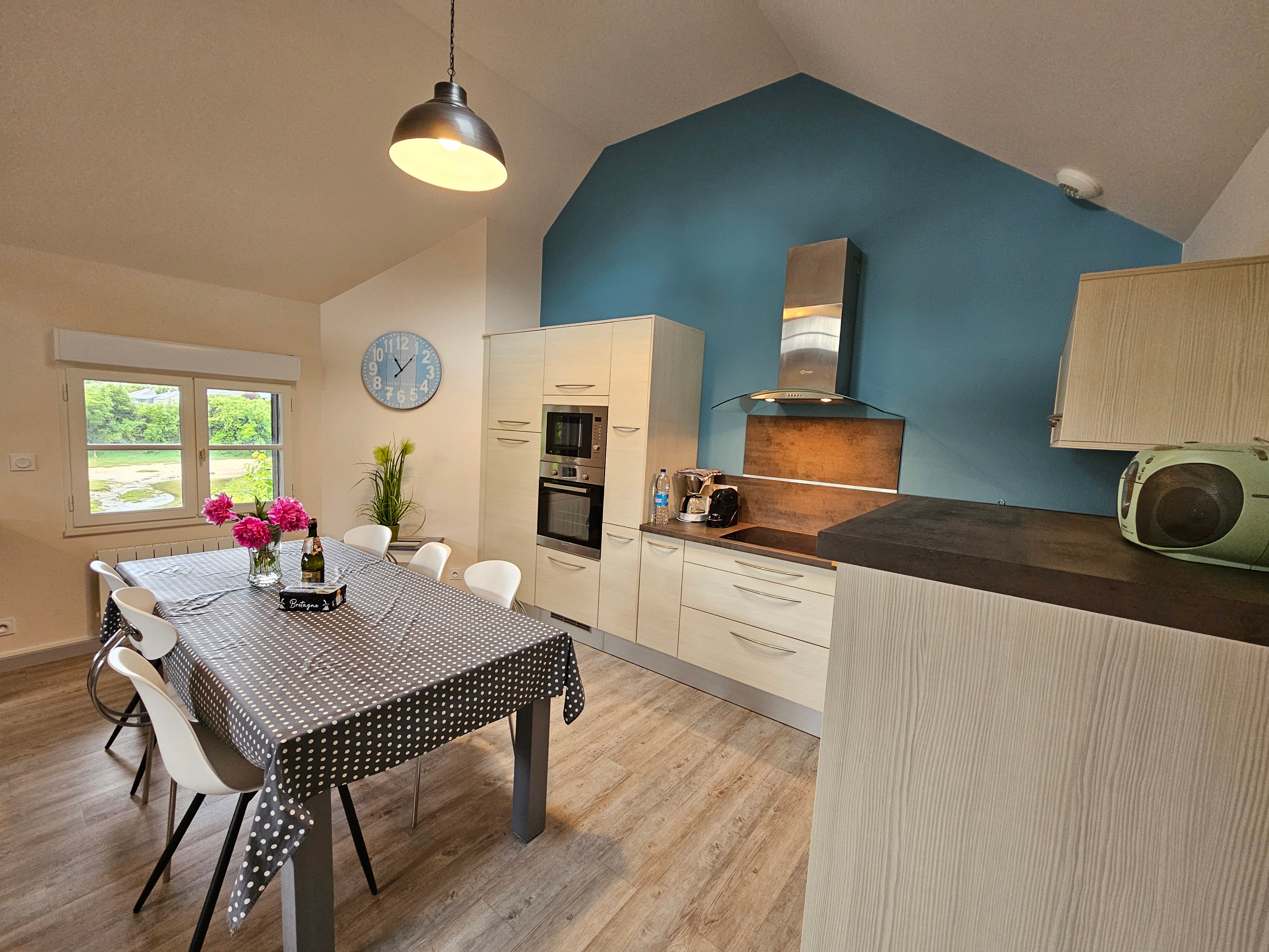 Living room with fitted kitchen, lounge and sitting area. Access to private terrace.