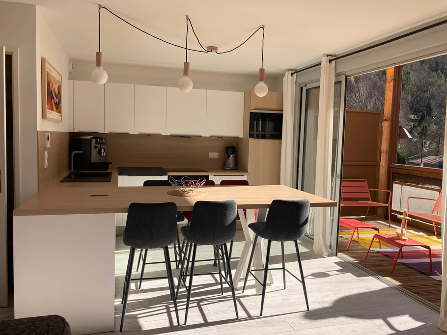 Cuisine ouverte sur salon et terrasse vue Montagne