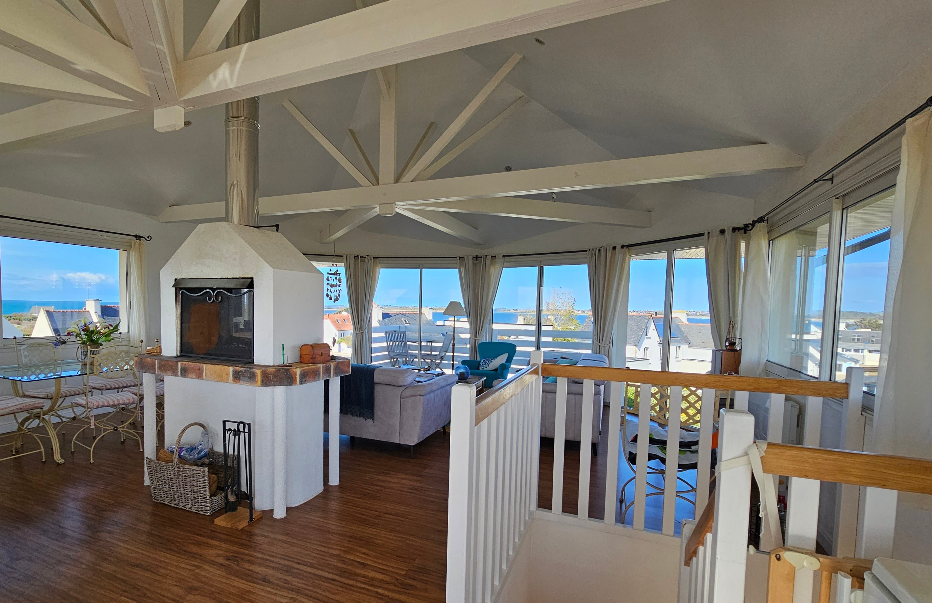 The living room with its beautiful roof structure and sea views
