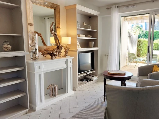 Salon avec TV dans une pièce de vie lumineuse en rez-de-jardin. Terrasse ombragée en accès direct.
Crédits photo : Yannick Goulvestre