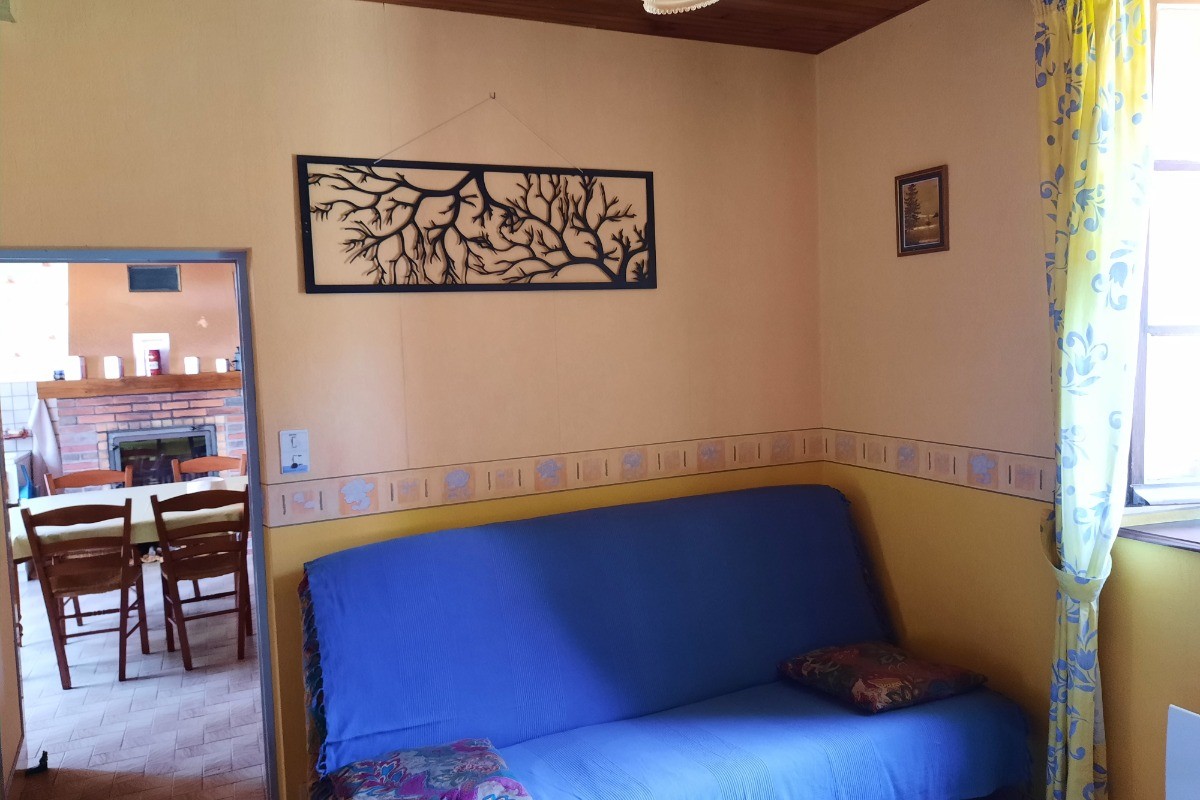 Gîte Clévacances, Chéniers, Creuse - Salon avec TV et canapé convertible (côté nord)
