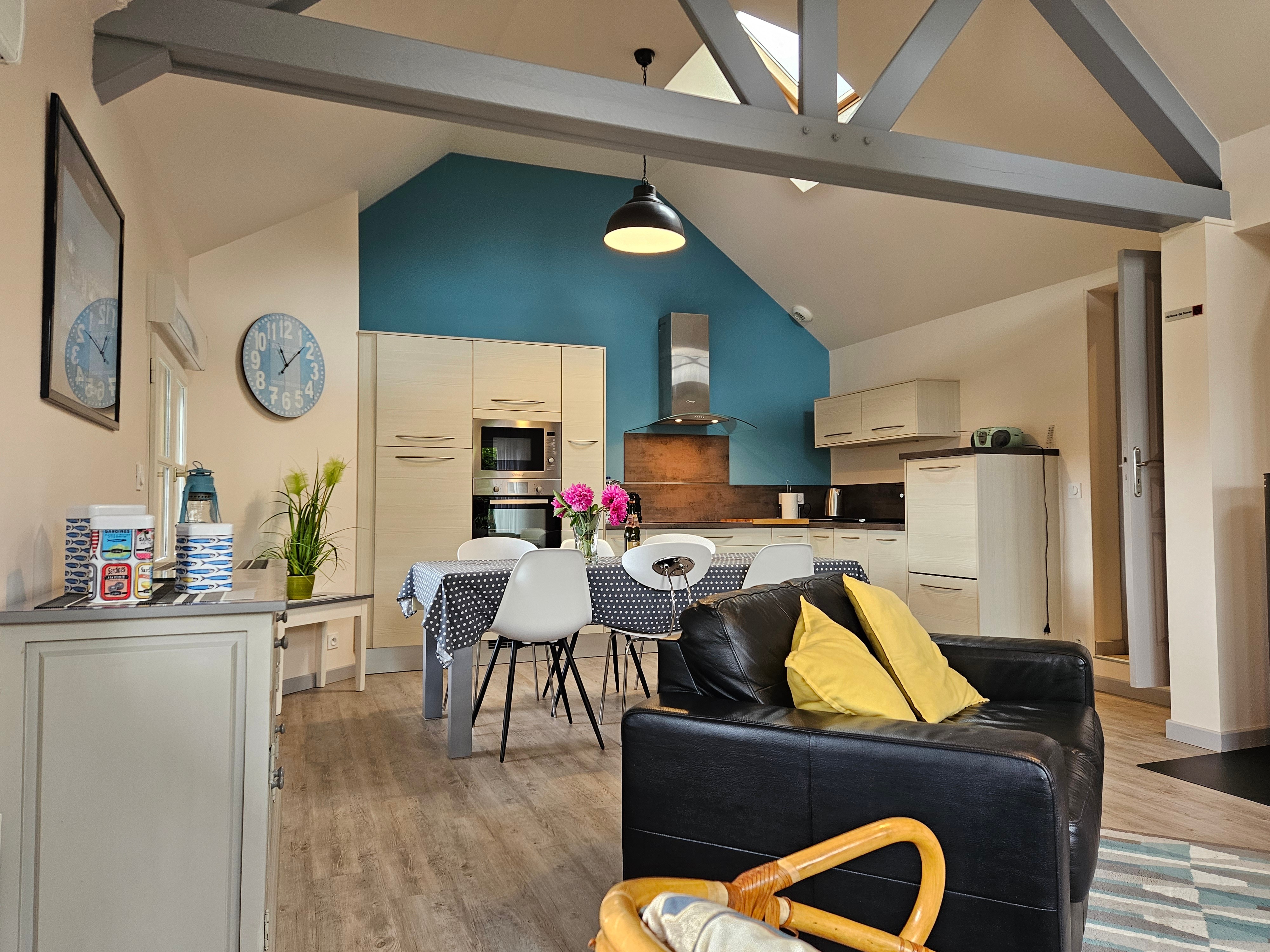 Living room with fitted kitchen, lounge and sitting area. Access to private terrace.
