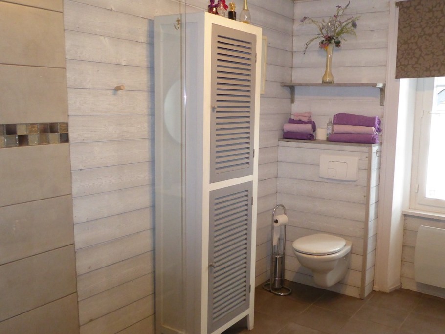 Spacious shower room with walk-in shower, vanity unit and wall-hung WC. M. COUPLIERE