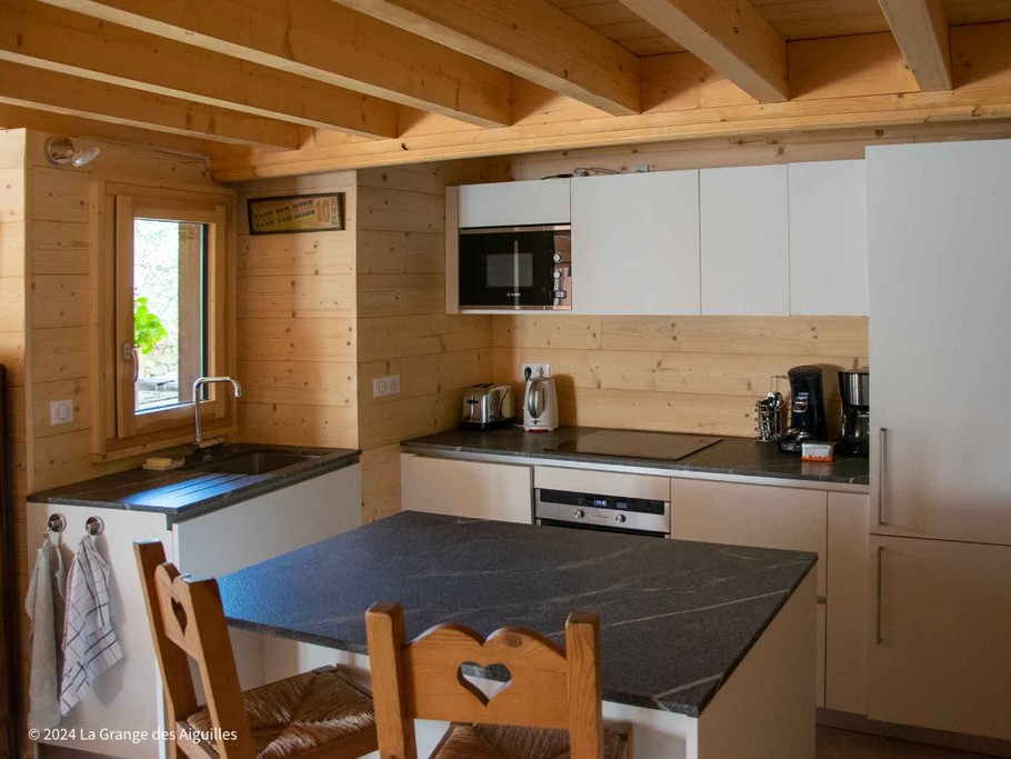 La cuisine, bien équipée, et son ilôt