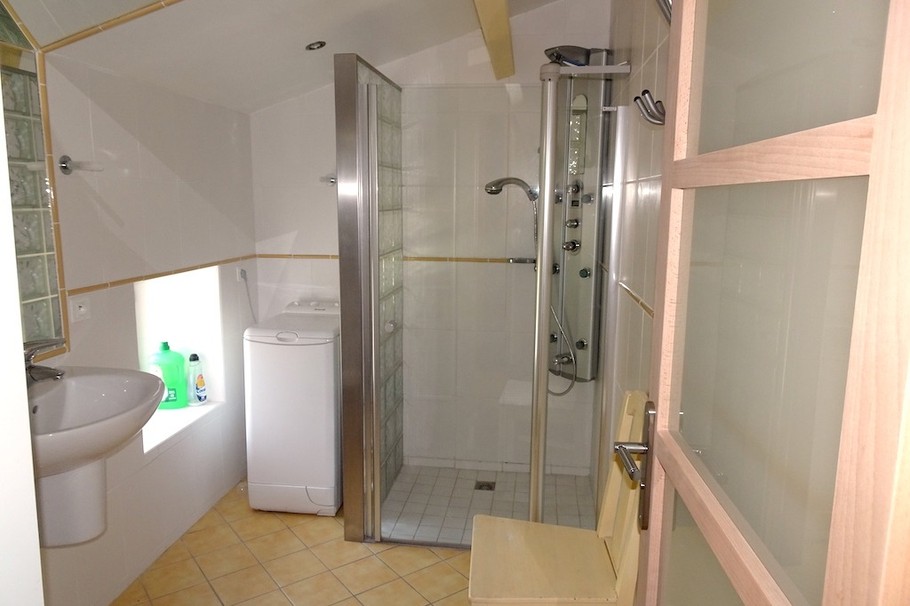 La salle d'eau à l'étage avec machine à laver le linge