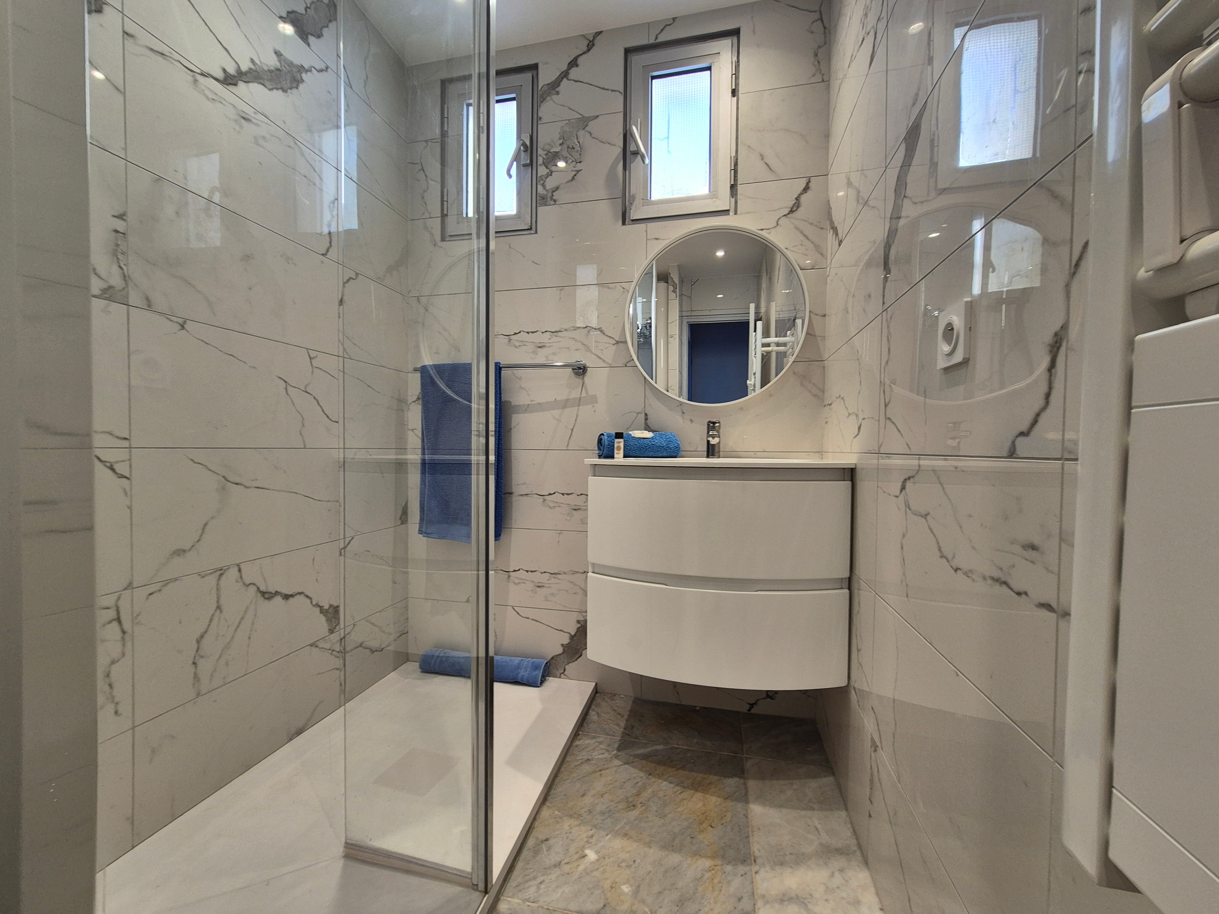 Salle d’eau moderne avec grande douche, pratique après une journée à la plage