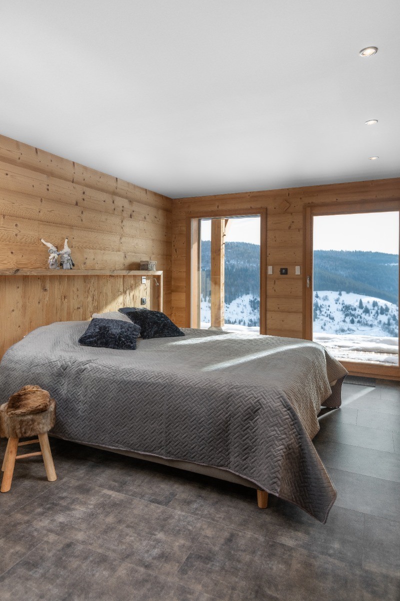 Bedroom on basement level with double bed 160X200, French window opening onto terrace and 4K television - Chalet du Paradis Blanc, in La Bresse with private sauna & spa sleeps up to 10