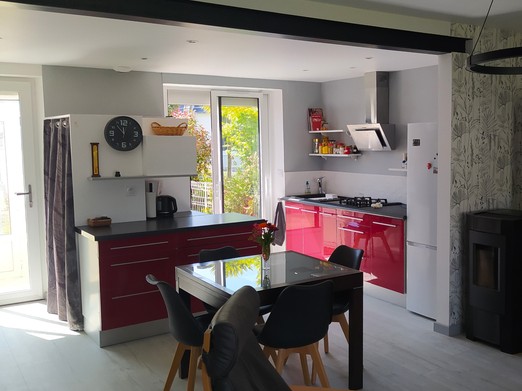 Ground floor living area with entrance hall, kitchen, lounge and wood-burning stove.