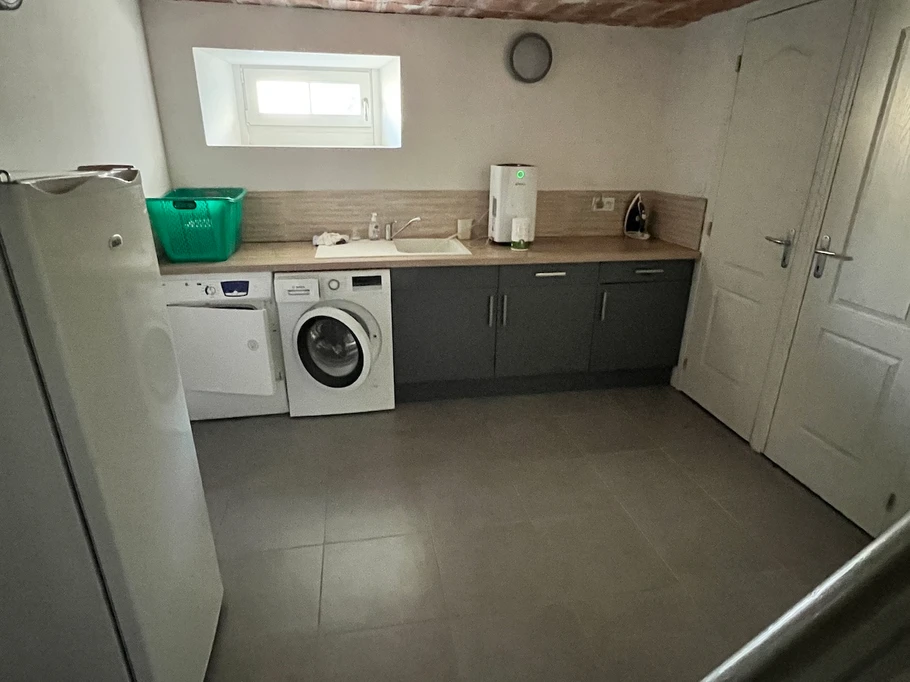 There is a large laundry room in the basement, equipped with a washing machine and dryer.