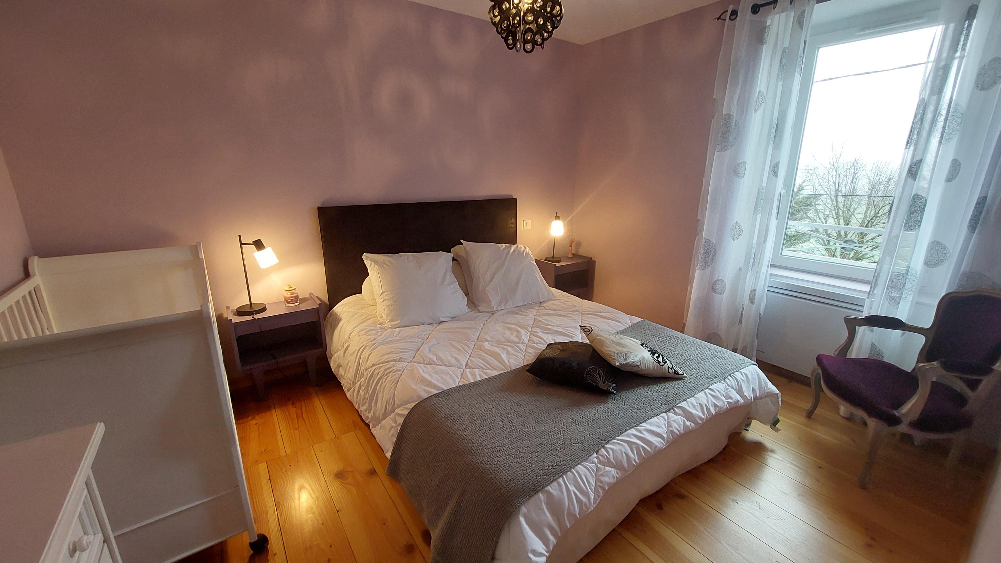 parental bedroom with cot ideal for a family Cantal gîte