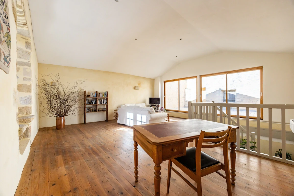 Au 1er étage le salon avec télévision et son bureau avec vue sur la terrasse privée de 30 m², à Bazas en Gironde