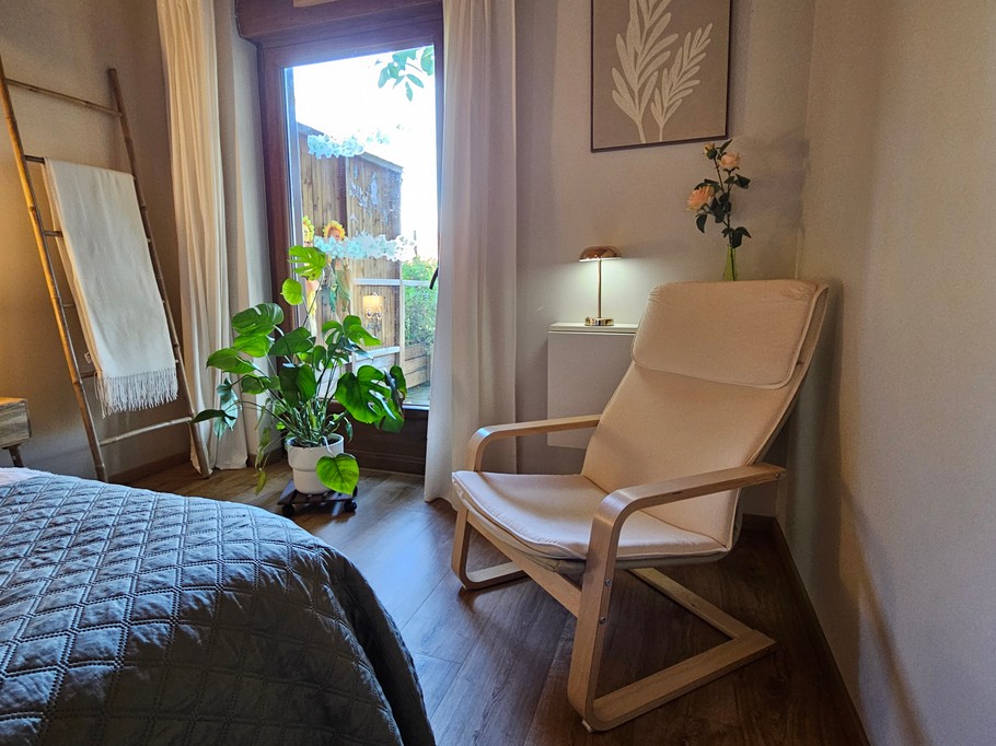 A large double bedroom with a walk-in wardrobe and a desk.