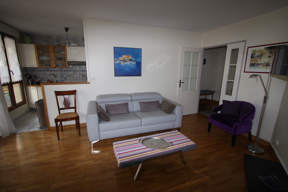 Espace salon donnant sur cuisine ouverte