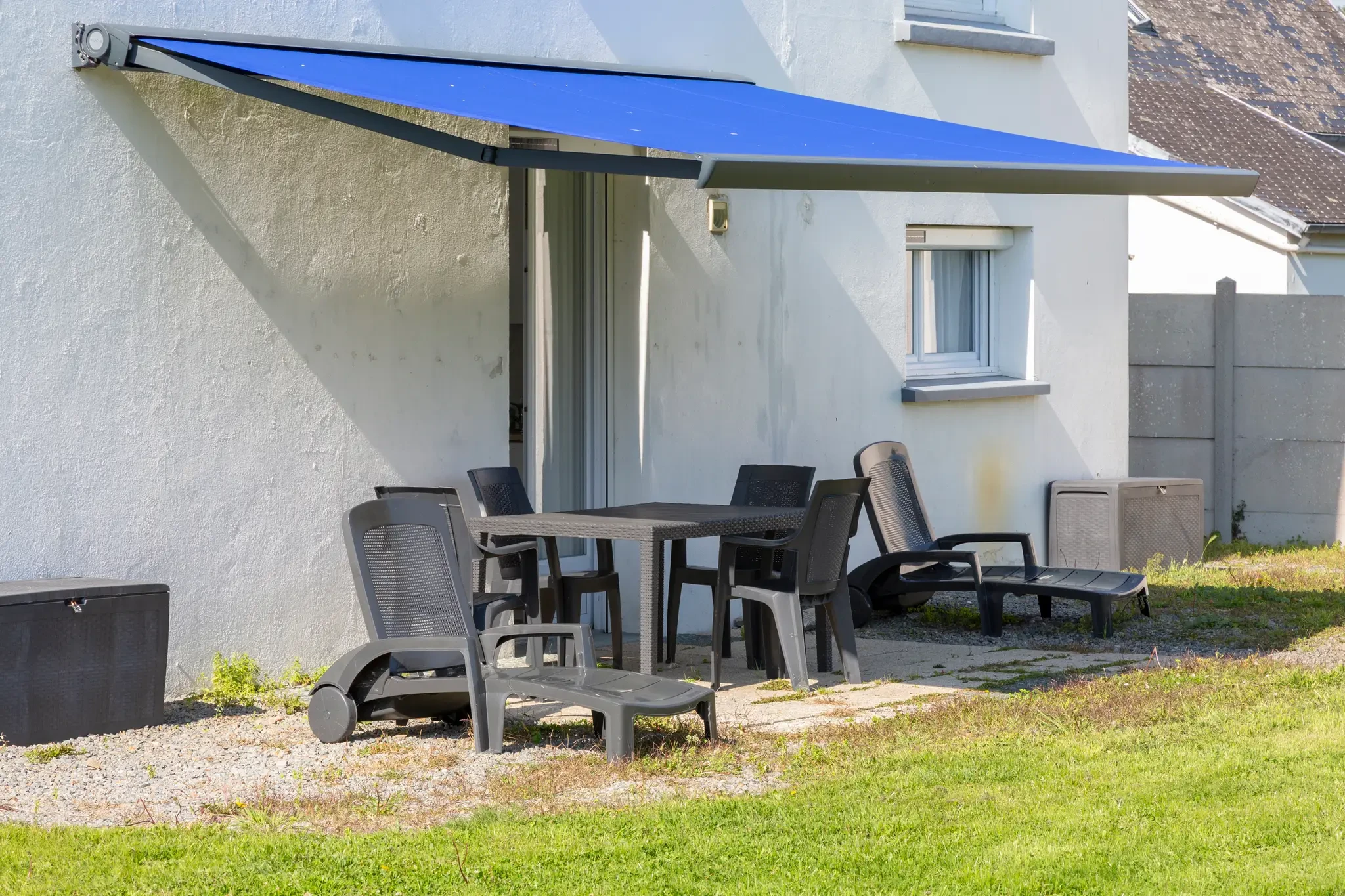 Terrace with awning and sun loungers