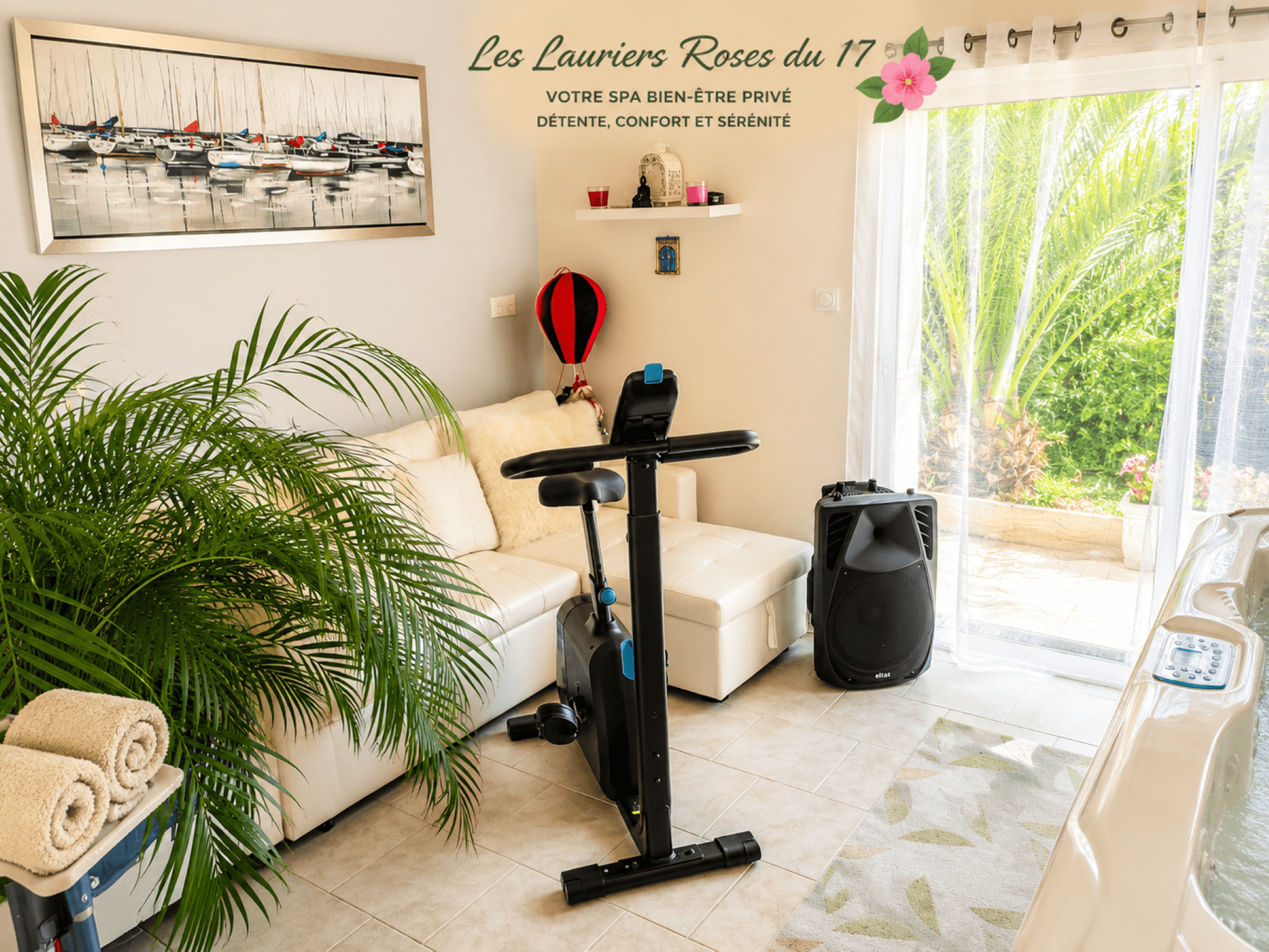 In the conservatory opening onto the garden, there is a sofa, an exercise bike and a hot tub at Gîte Les Lauriers Roses du 17 in Charente-Maritime, accommodating 2 to 4 people, with a hot tub