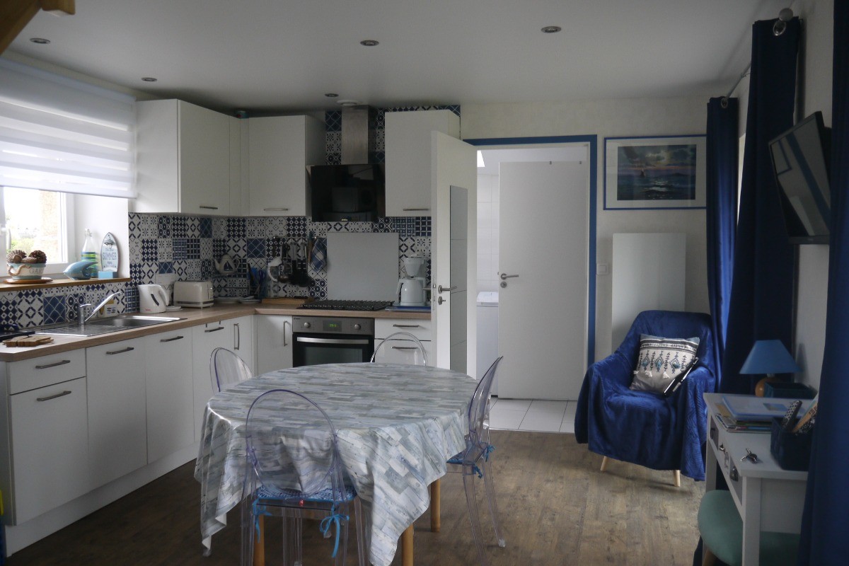 cuisine dans pièce à vivre, porte donnant sur la salle de bain