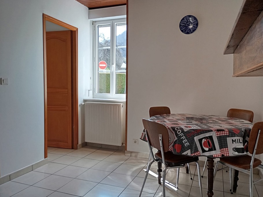 Separate kitchen with adjoining small utility room with ironing board, clothes line and vacuum cleaner......