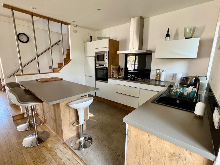 Fully equipped modern kitchen with breakfast island and appliances