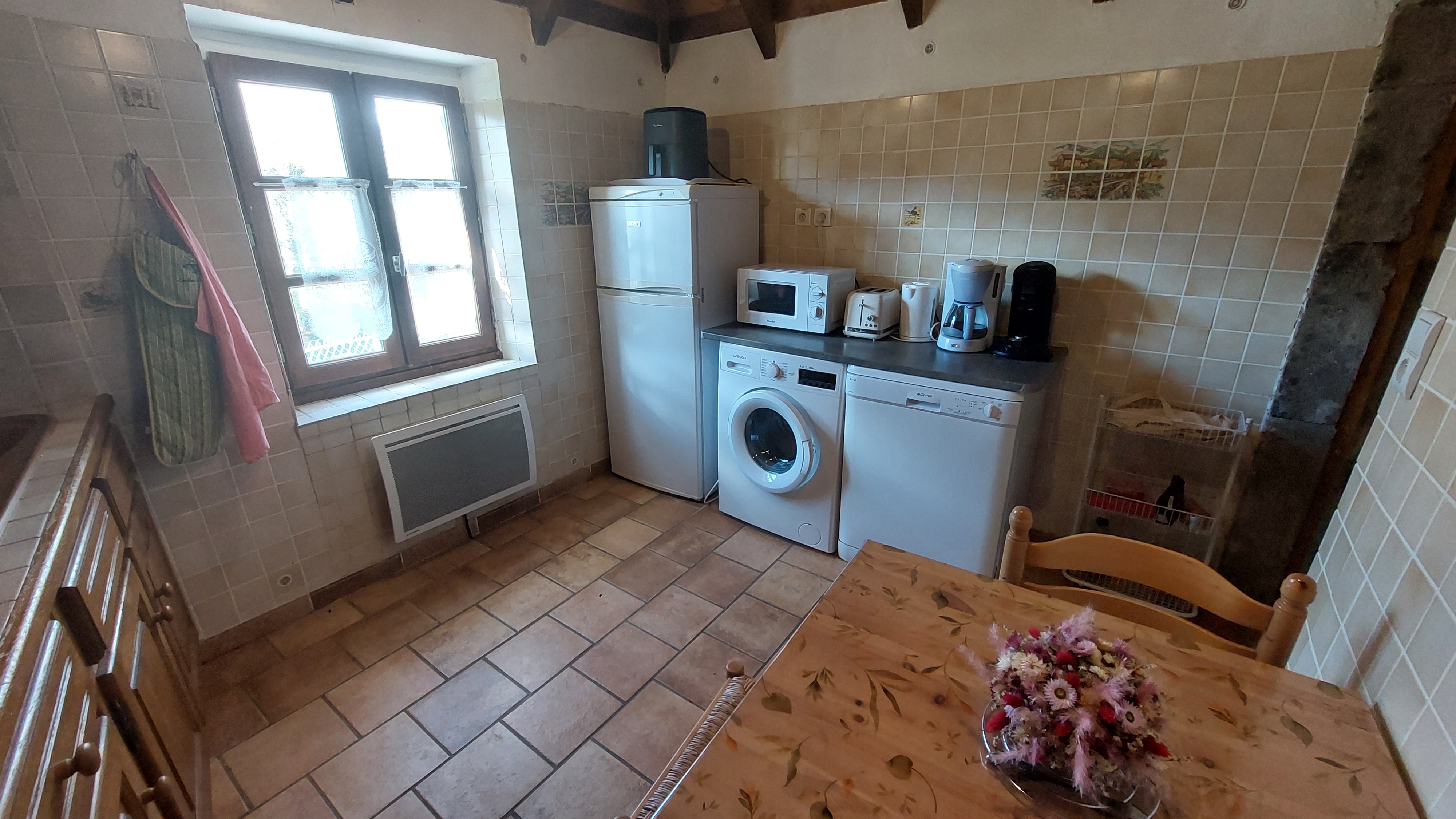 Kitchen with appliances and dining area in a character house