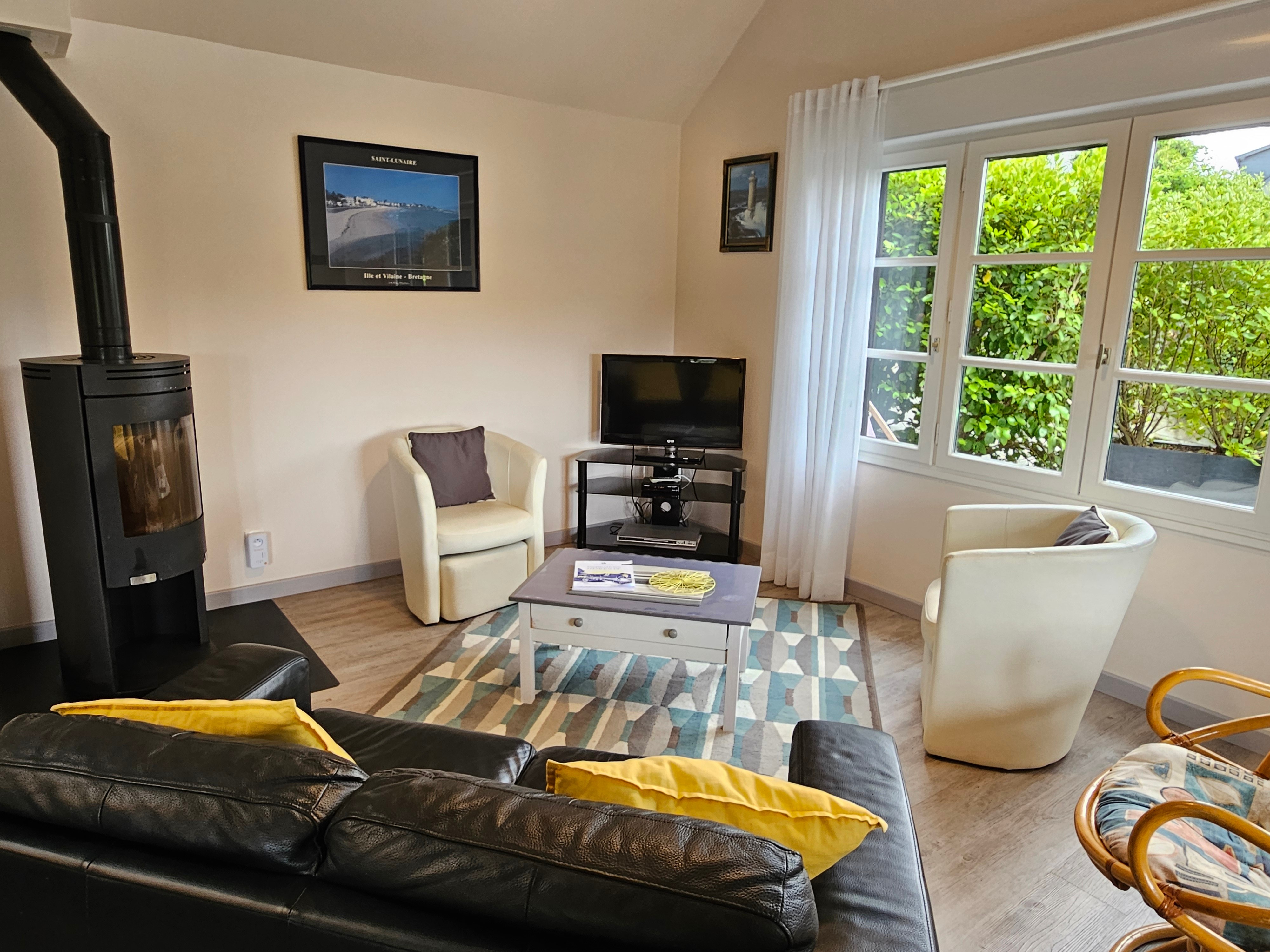 Living room with fitted kitchen, lounge and sitting area. Access to private terrace.