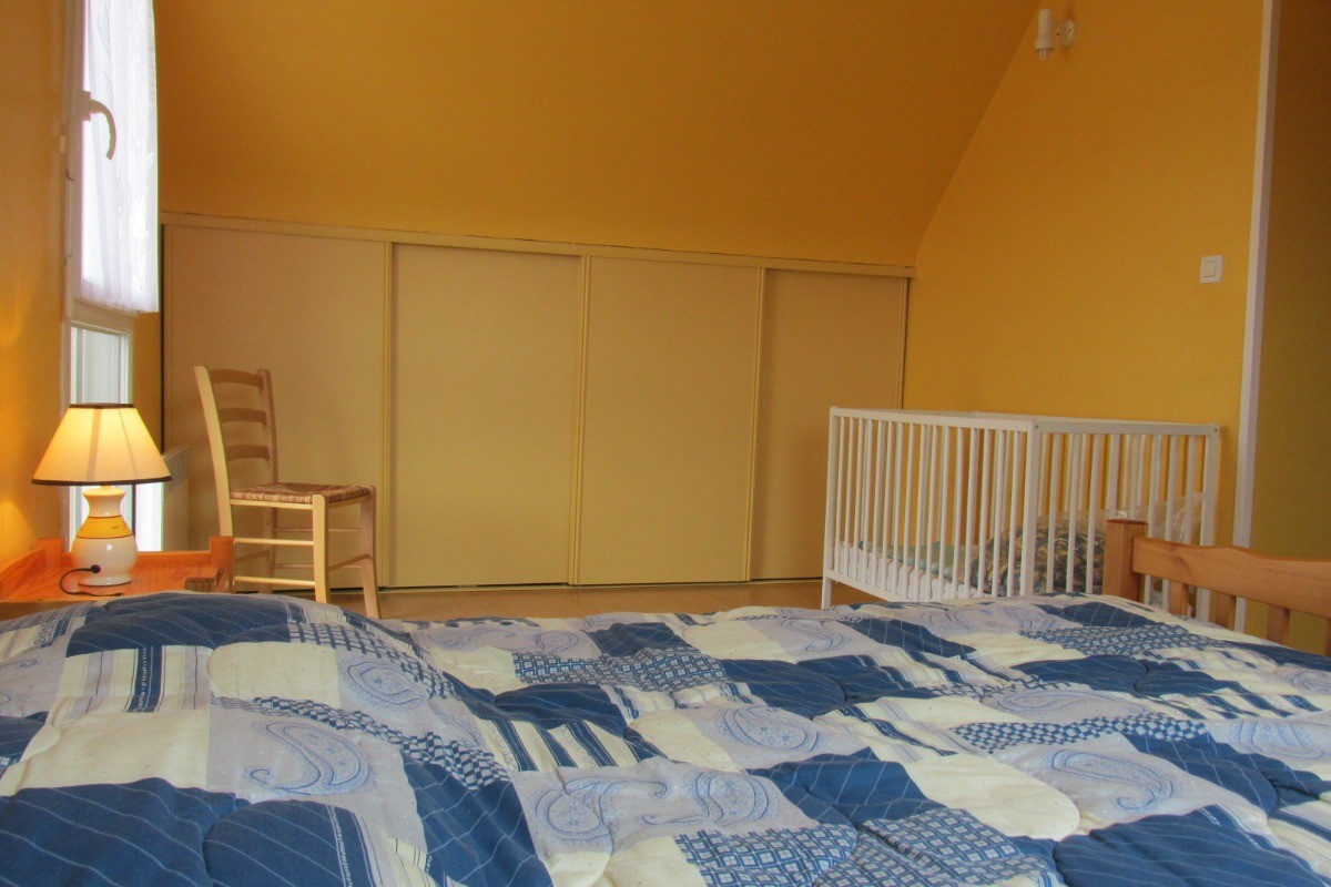 The upstairs master bedroom with a cot