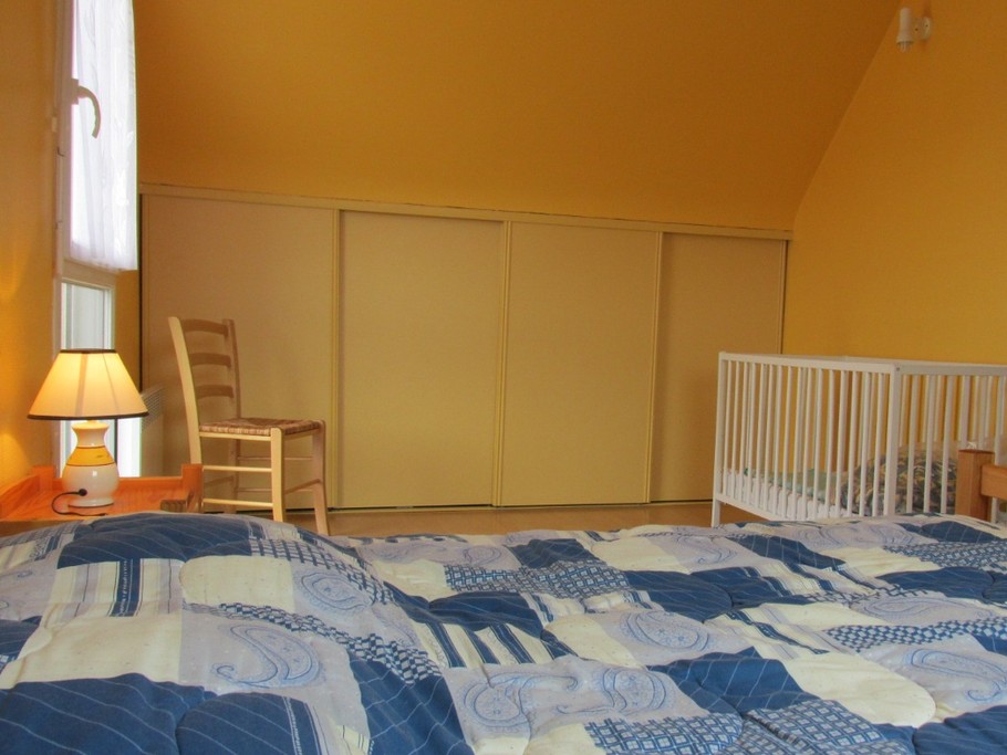 The upstairs master bedroom with a cot