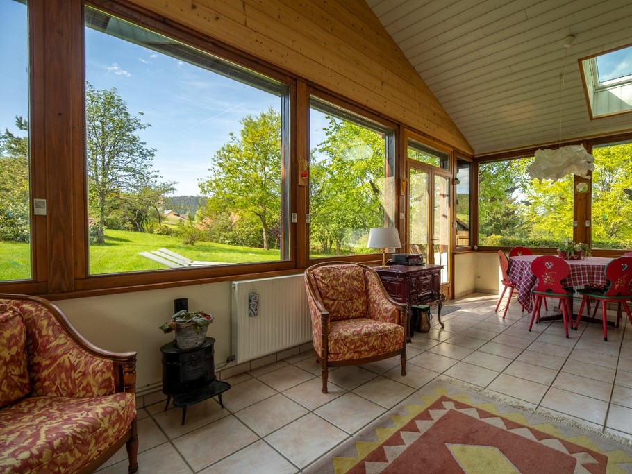 L'espace de lumière de la véranda avec accès sur la terrasse extérieure,