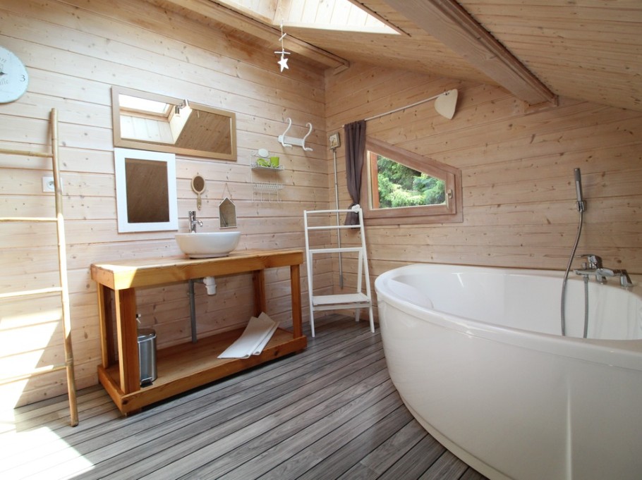 Salle de bain avec baignoire, toilettes et matériel de puériculture mis à disposition.