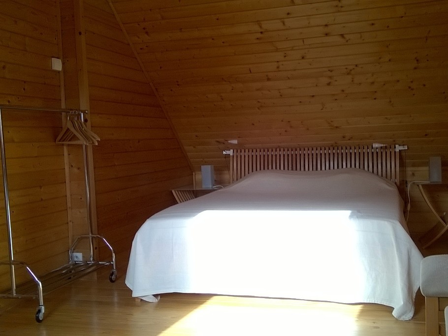 Une des chambre de l'étage avec son grand lit double et un lit simple