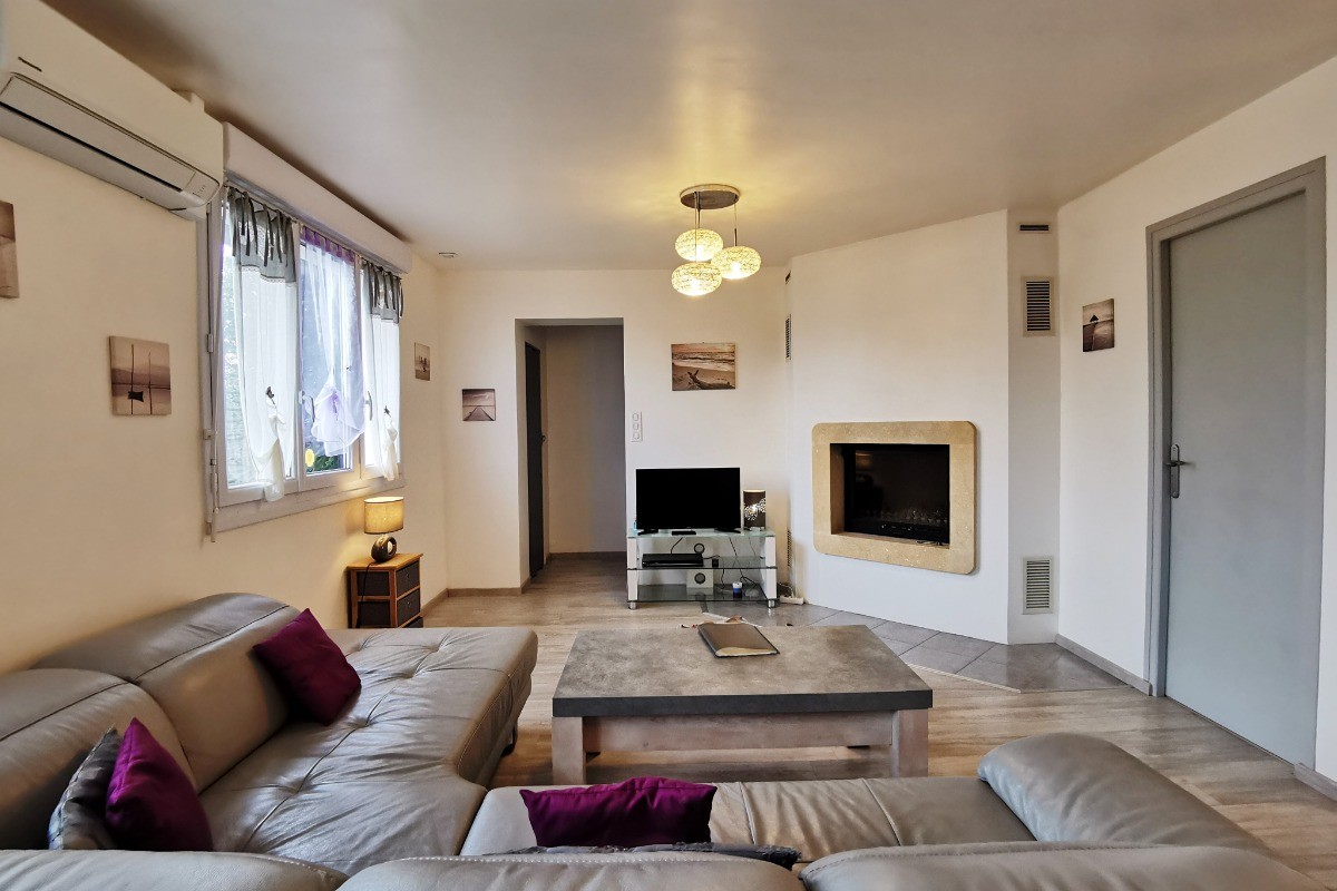 salon avec TV et cheminée insert