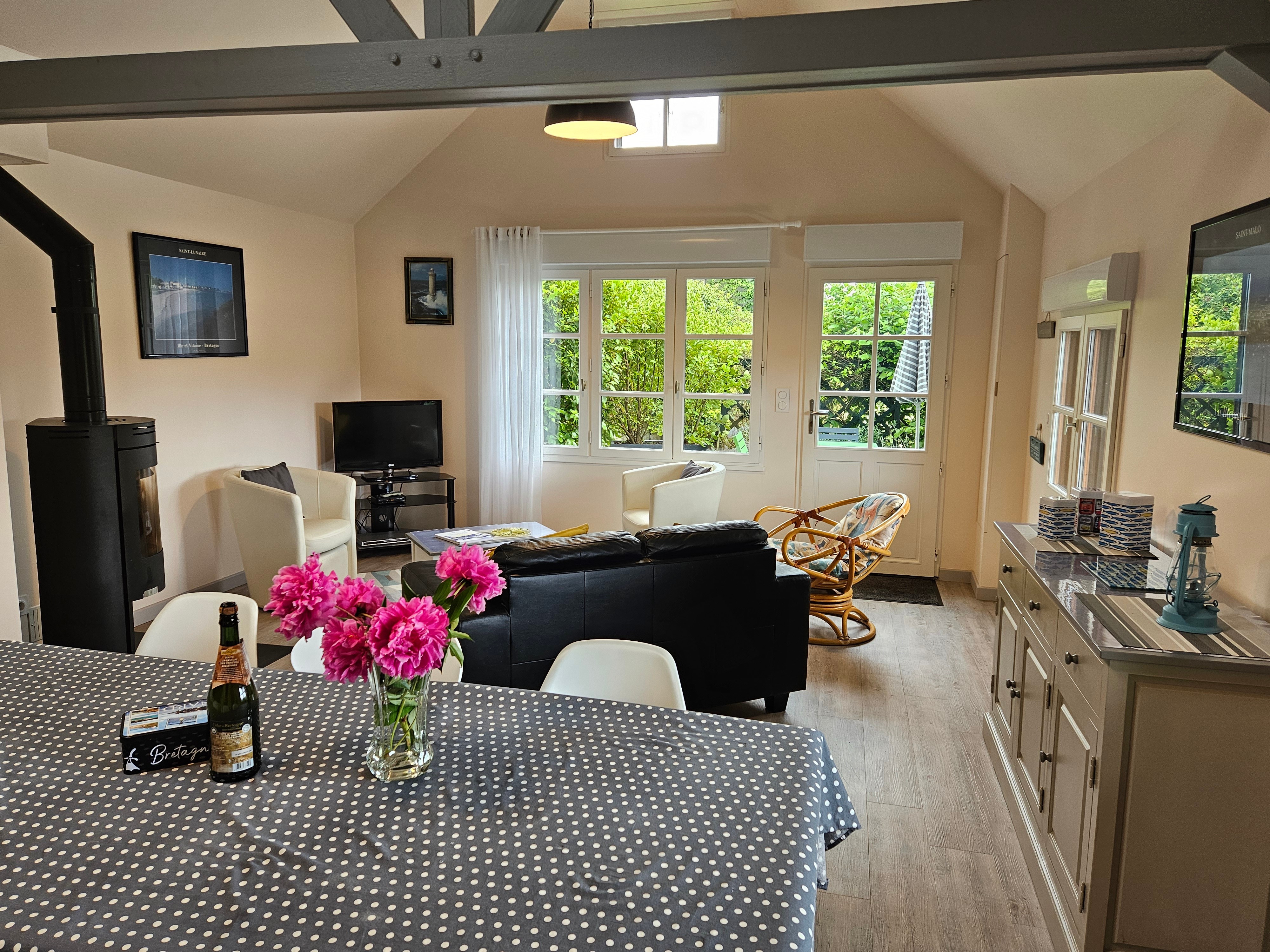 Living room with fitted kitchen, lounge and sitting area. Access to private terrace.